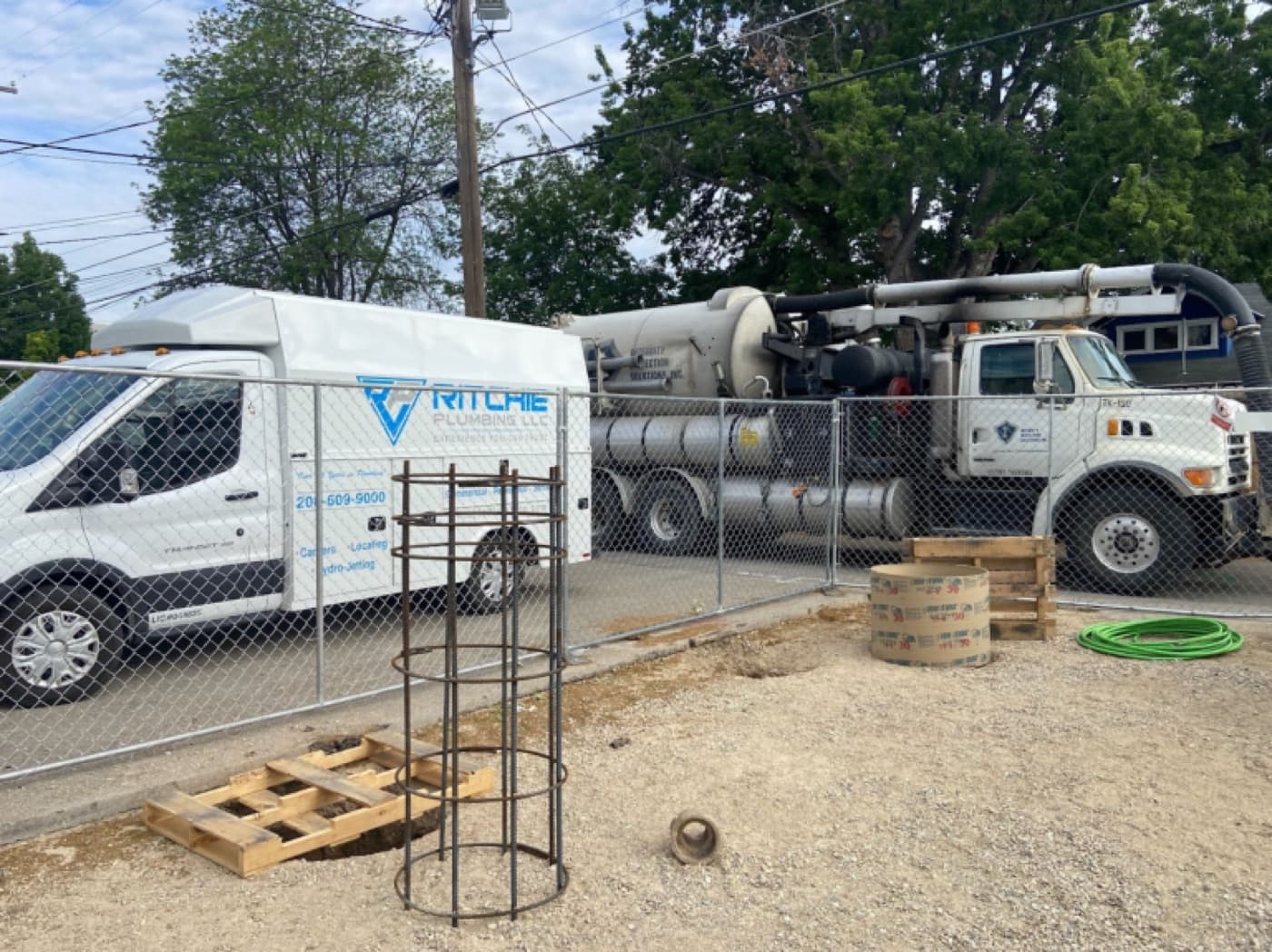 Ritchie Plumbing van alongside a vacuum truck at a sewer and water main job